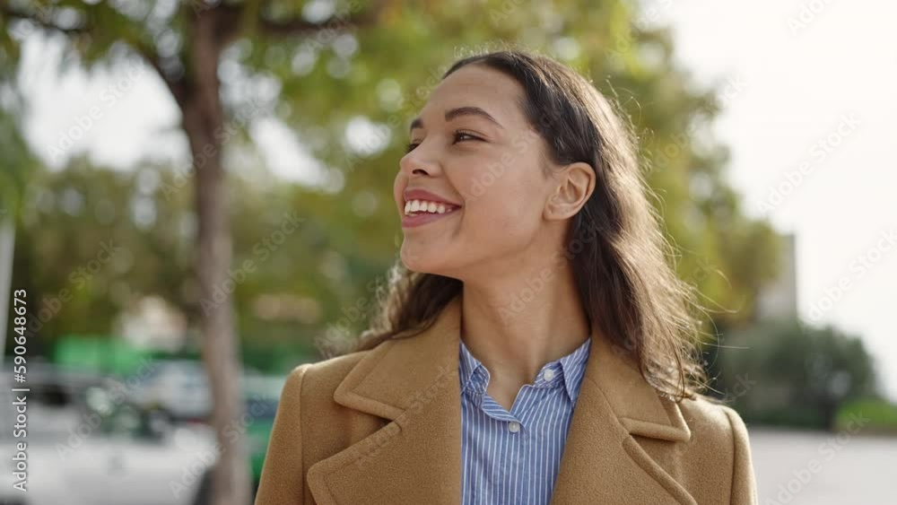 Young beautiful hispanic woman smiling confident at park