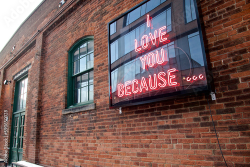 Photography Neon sign on a brick wall. Love concept.