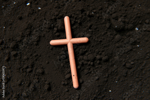small wooden cross on the ground as a symbol of faith and religious devotion
