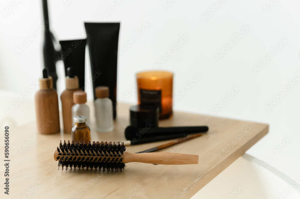 a wooden comb lies on a wooden stand with bathroom accessories for body care. bathroom concept a wooden comb lies on a wooden stand with bathroom accessories for body care. bathroom concept