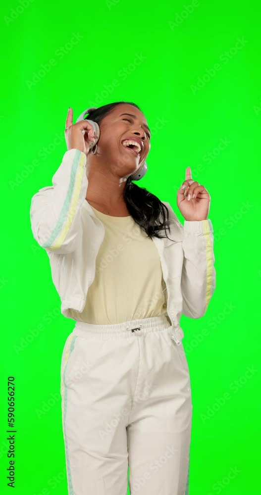 Green screen, smile and woman with headphones, dancing and happiness on studio background. Female, song and happy person with headset, streaming music and dance with energy, pointing up and cheerful Green screen, smile and woman with headphones, dancing and happiness on studio background. Female, song and happy person with headset, streaming music and dance with energy, pointing up and cheerful