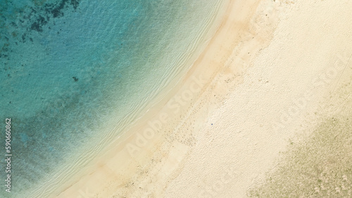 White sand beach and ocean in Hawaii top-down aerial drone view. 