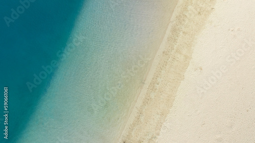 White sand beach and ocean in Hawaii top-down aerial drone view. 