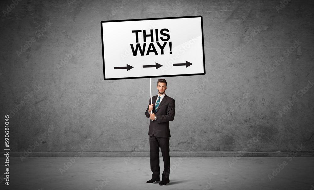 business person holding a traffic sign concept business person holding a traffic sign concept