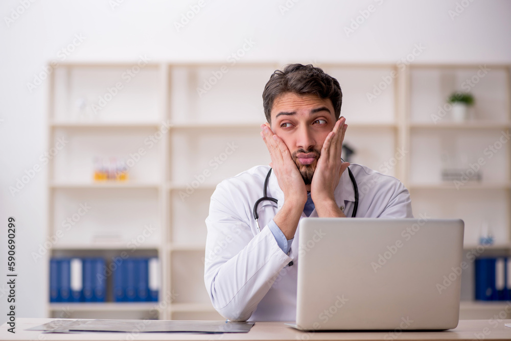 Young male doctor in telemedicine concept Young male doctor in telemedicine concept