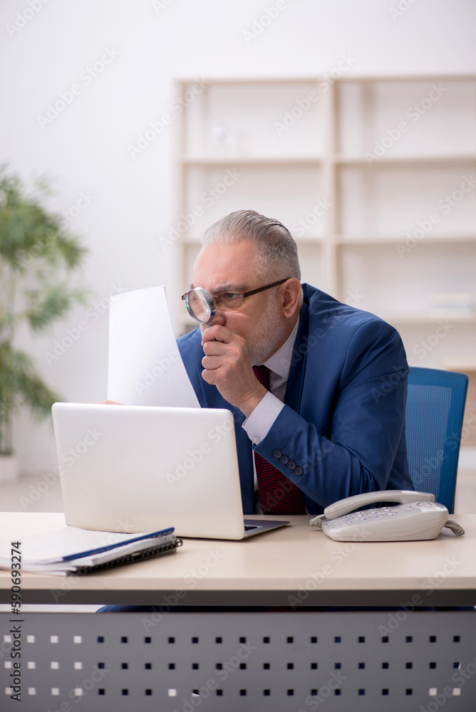 Old male employee and too much work at workplace Old male employee and too much work at workplace