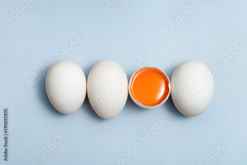 Top view egg yolk and egg white high protein good for body blue background.