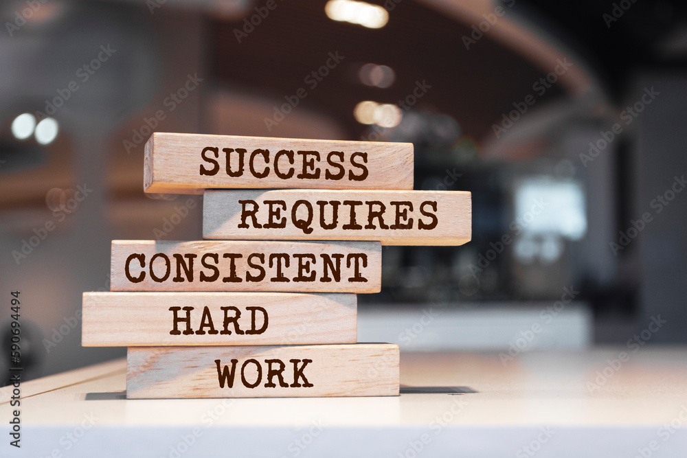 Wooden blocks with words 'Success requires consistent hard work'. Motivation concept