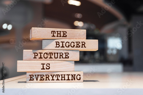 Wooden blocks with words 'The bigger picture is everything'. Motivation concept photo