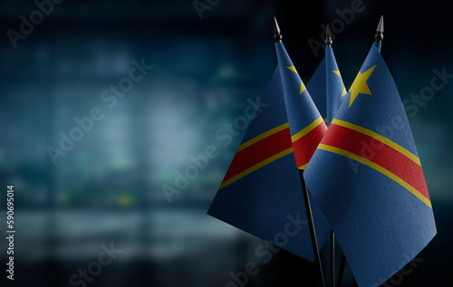 Small flags of the Democratic Republic of the Congo on an abstract blurry background