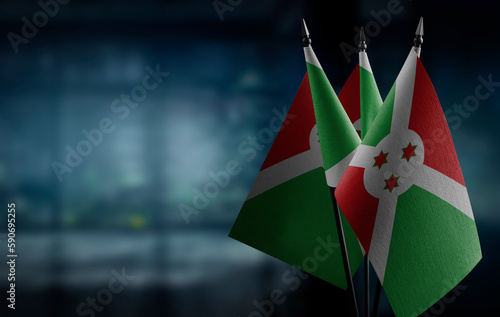 Small flags of the Burundi on an abstract blurry background photo