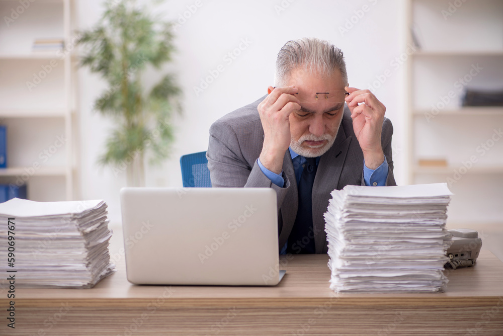 Old male employee and too much work in the office Old male employee and too much work in the office