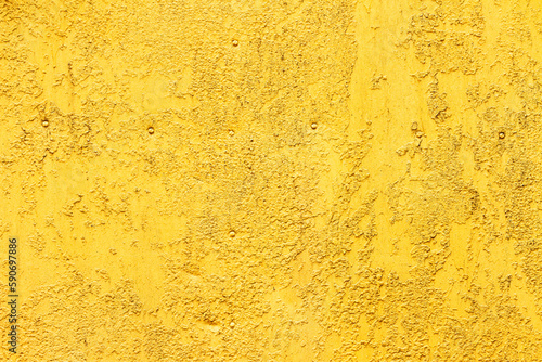 rusty metal surface with rivets painted yellow. industrial weathered background.