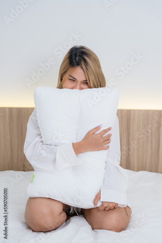 cute asian girl funny on bed with pillow