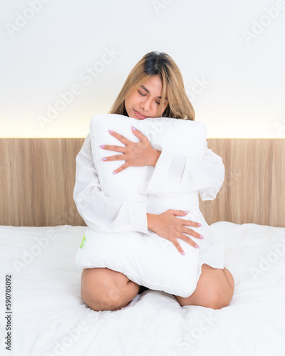 cute asian girl funny on bed with pillow