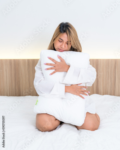 cute asian girl funny on bed with pillow
