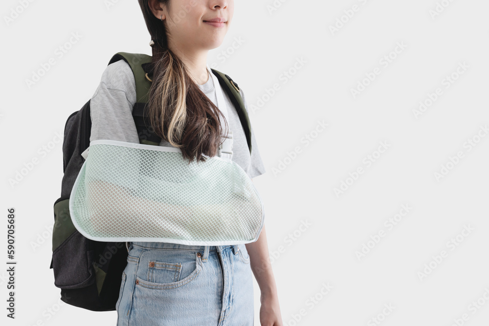 Travel insurance concepts. Young woman with hand injured wearing splint, broken arm, wearing backpack, smiling face, isolated on white background