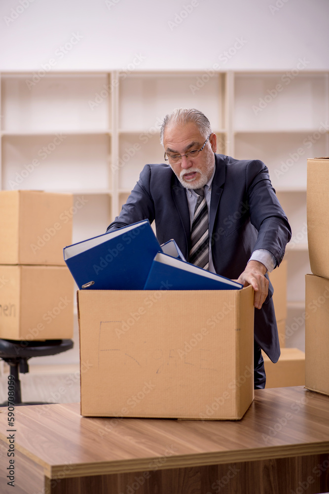 Old male employee in office relocation concept Old male employee in office relocation concept