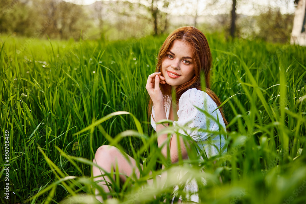 happy smiling redhead woman resting sitting in tall grass happy smiling redhead woman resting sitting in tall grass