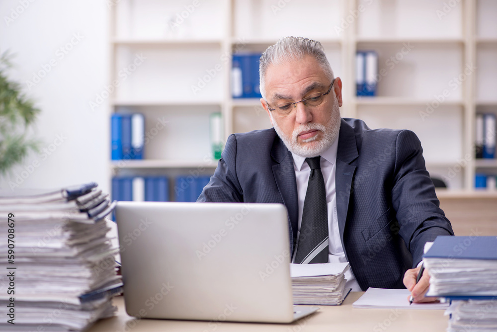 Old male employee and too much work at workplace Old male employee and too much work at workplace