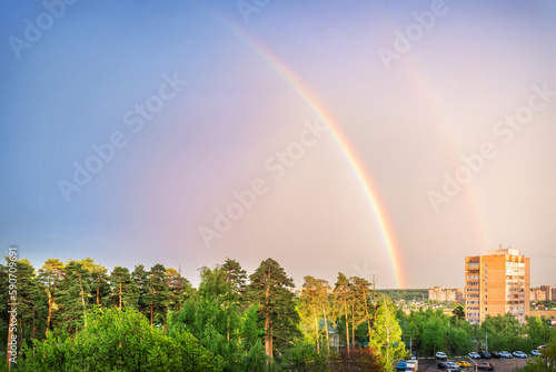 Quadro em tela Half of the rainbow over the forest and residential building, Moscow region
