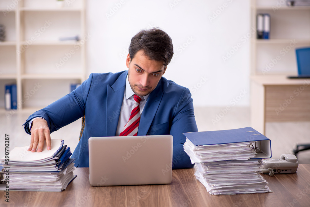 Young male employee working in the office Young male employee working in the office
