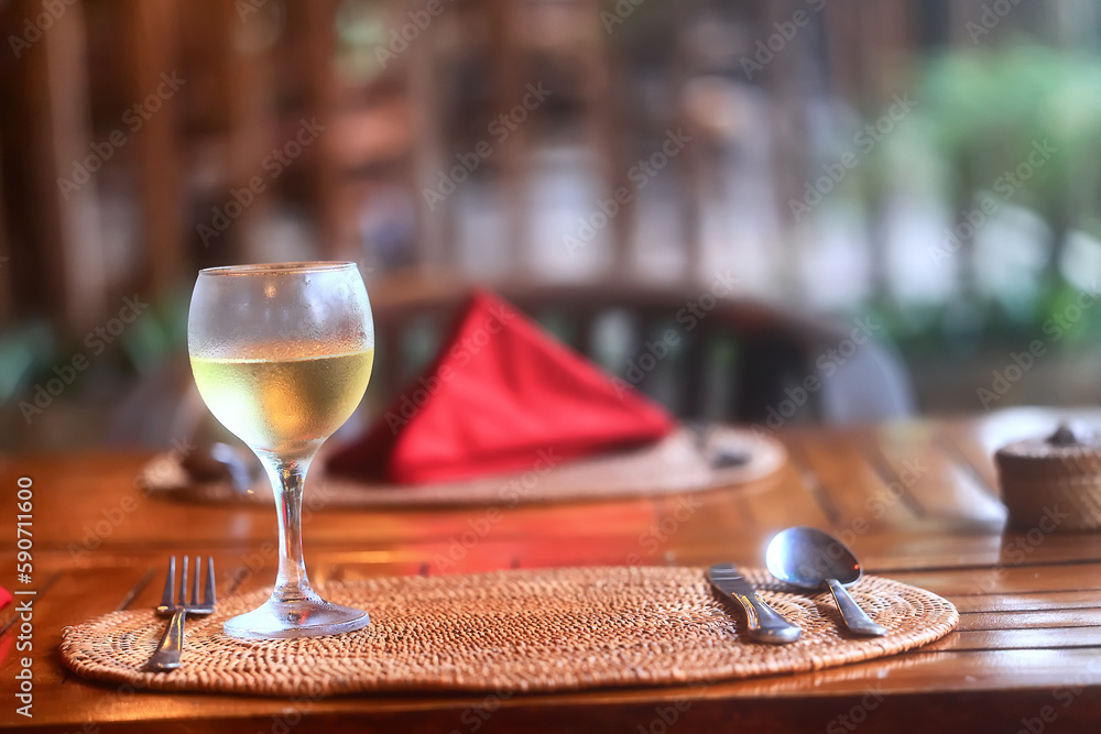 a glass of white wine in a restaurant, alcohol luxury background