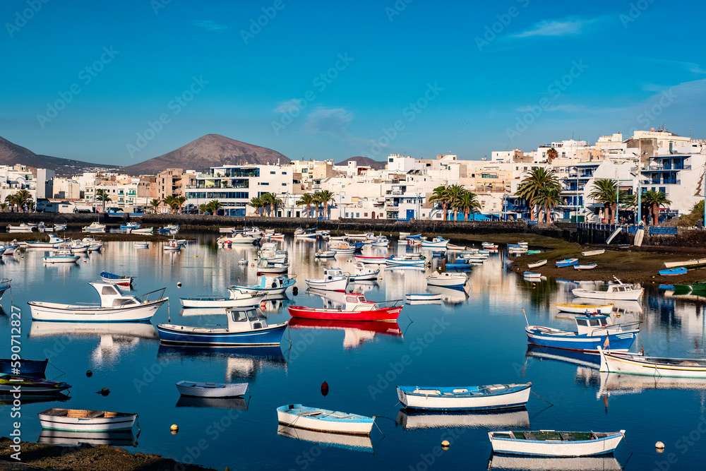 Fisher boats at the laguna Charco de San Gines at sunrise, city of Arrecife, Lanzarote, Canary Islands Fisher boats at the laguna Charco de San Gines at sunrise, city of Arrecife, Lanzarote, Canary Islands