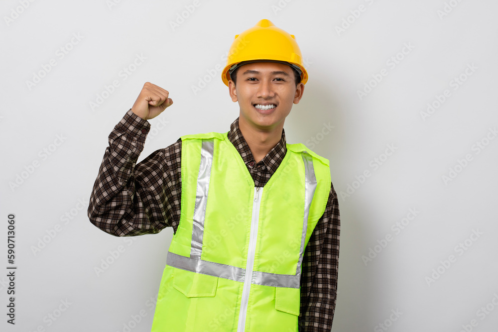 Young asian construction worker showing biceps muscles isolated on white background