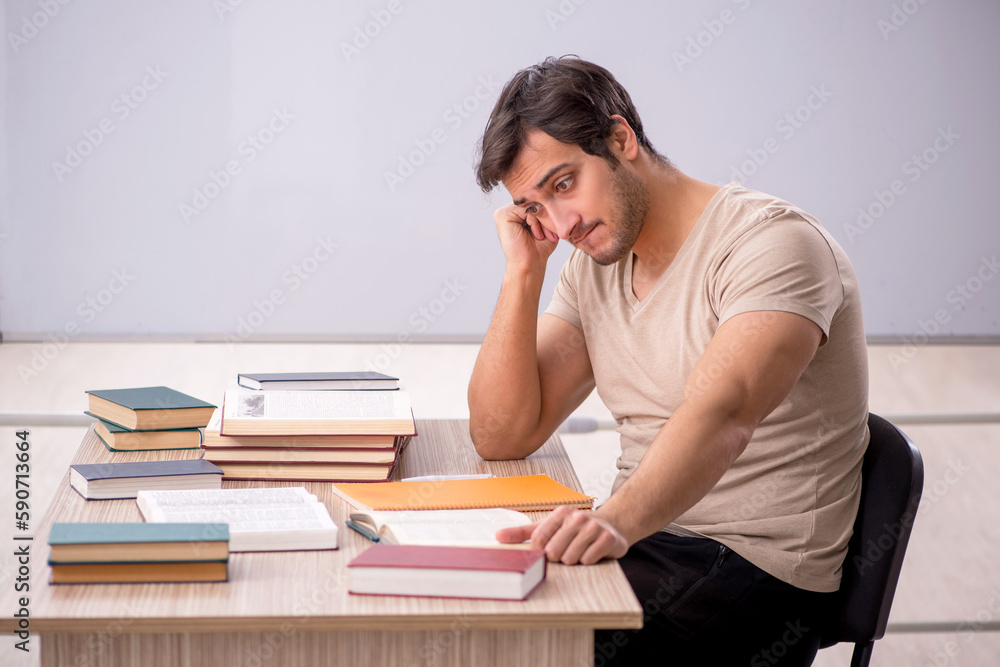 Young male student sitting in the classroom Young male student sitting in the classroom