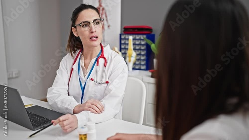 Wallpaper Mural Two women doctor and patient having consultation shake hands at clinic Torontodigital.ca