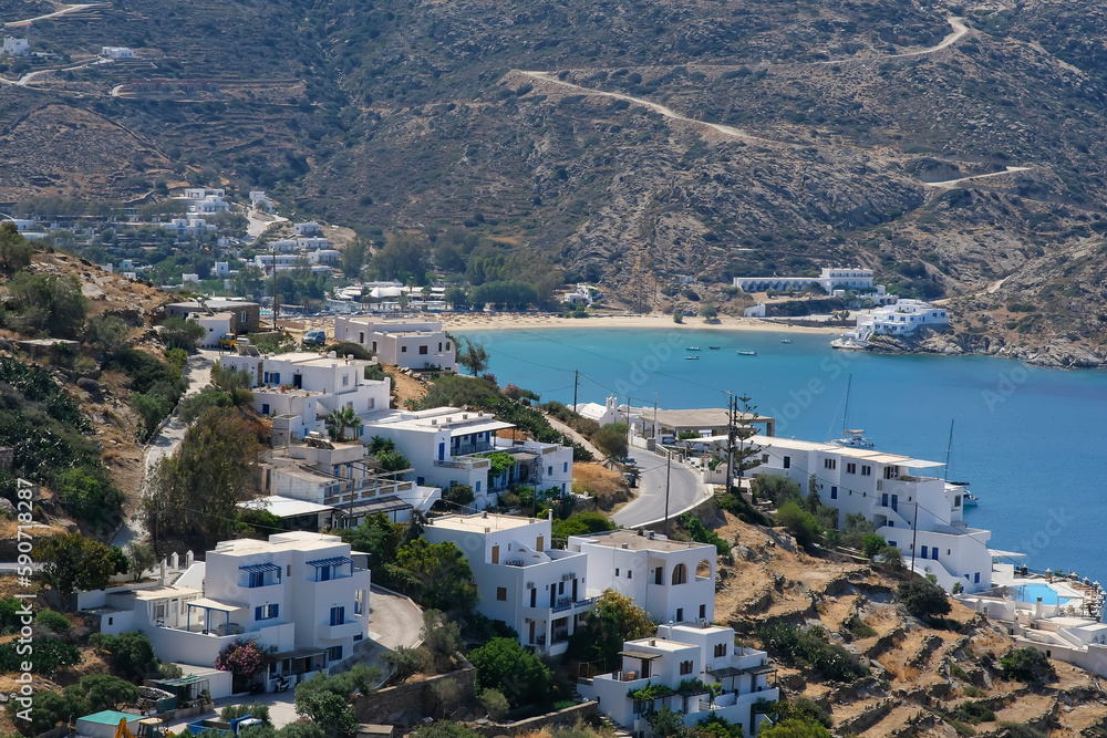 View of whitewashed hotels and a road leading to the famous Mylopotas beach in Ios Greece
