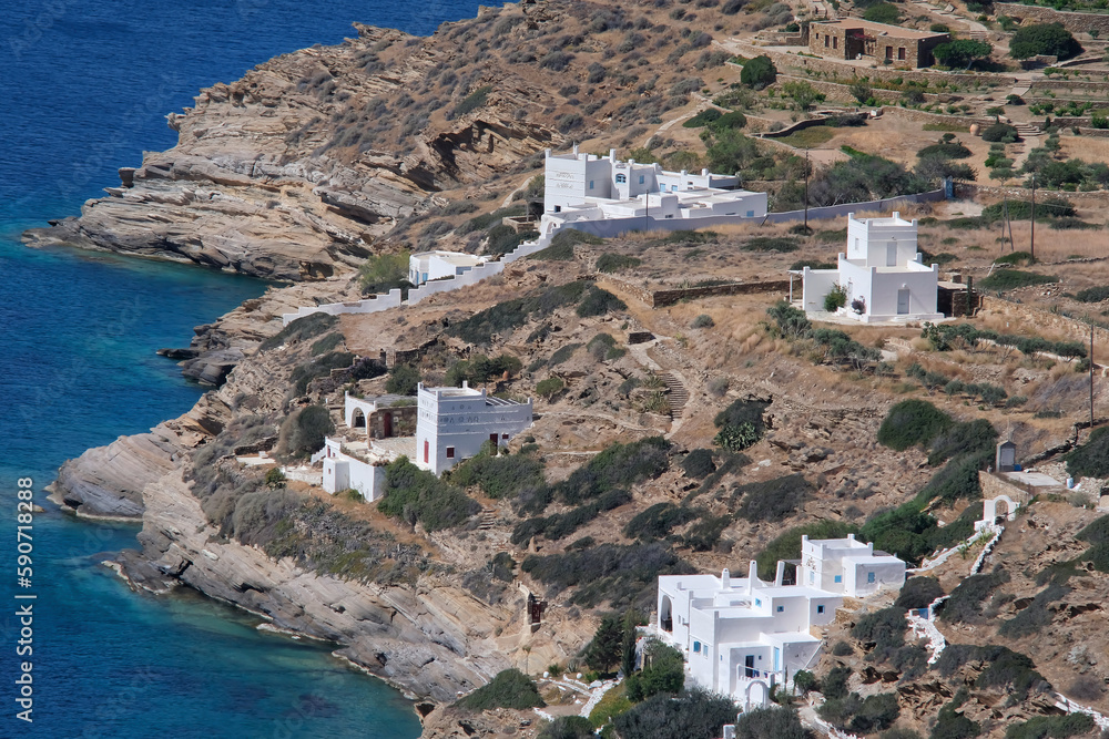View of various whitewashed summer villas next to the Aegean Sea in Ios Greece