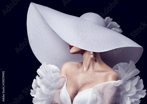 Elegant Lady in White Hat with Red Lips Make up. Fashion Woman in Luxury Evening Dress over Black. Beautiful Model in Big Wide Brimmed Hat and Wedding Gown
