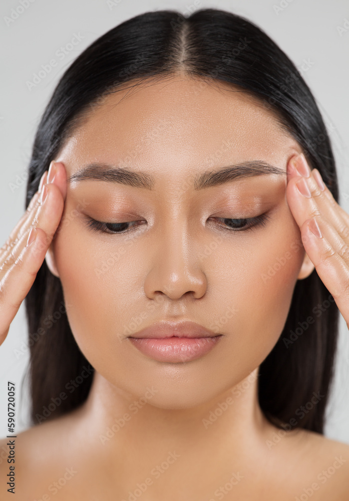 Beauty Woman Closeup Face Lift Massage. Beautiful Asian Model Portrait with Natural Make up. Women Facial Dermal Filler. Eyes Care Cosmetology and Plastic Surgery