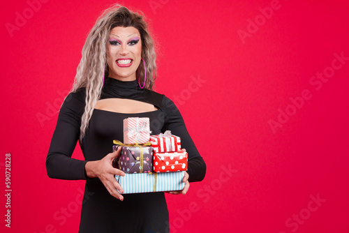 Fotografie Smiley transgender person with make up holding many gifts