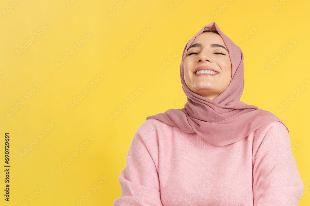 Fototapeta premium Happy muslim woman laughing with eyes closed