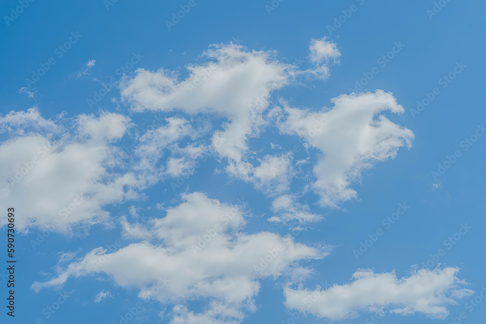 Fluffy white clouds in a clear blue sky. Fluffy white clouds in a clear blue sky.