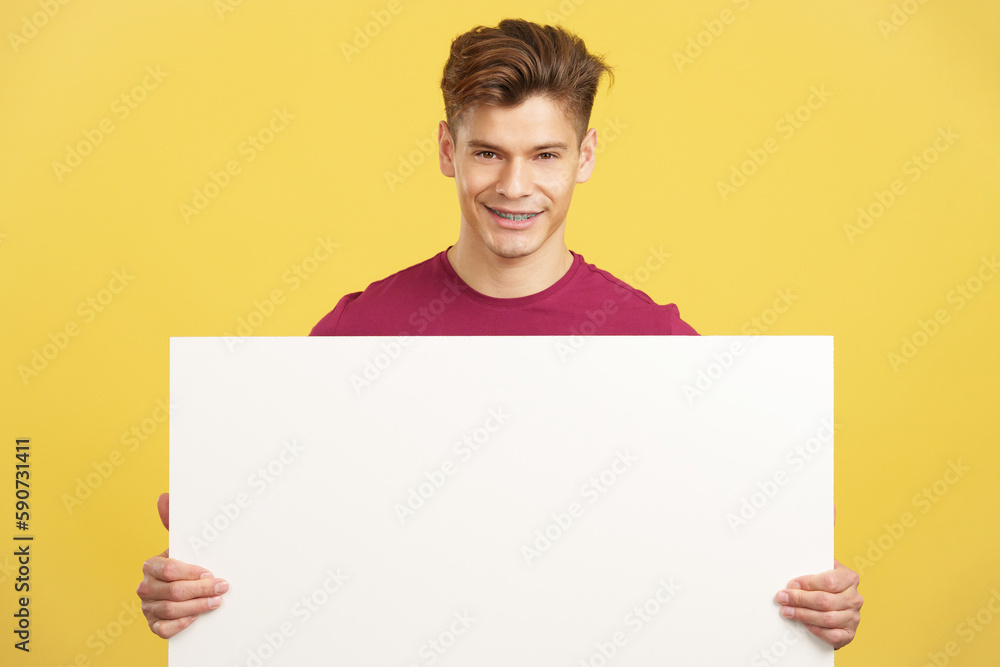 Caucasian man holding a blank panel smiling at the camera Caucasian man holding a blank panel smiling at the camera