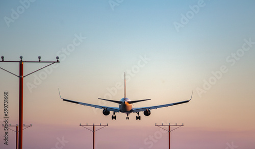 Airplane landing during sunset