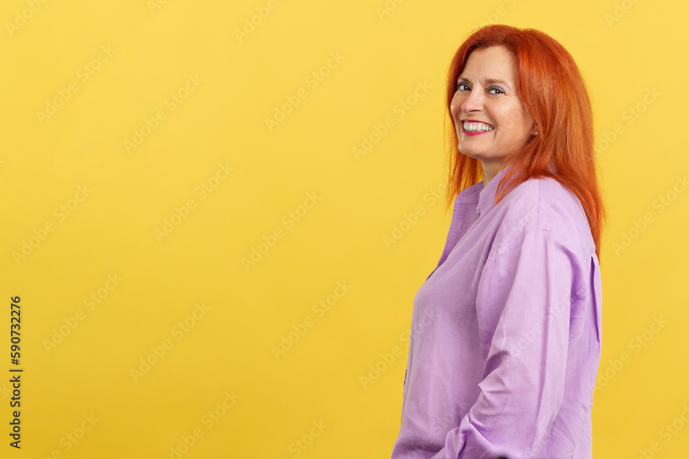 Happy redheaded mature woman smiling at the camera Happy redheaded mature woman smiling at the camera