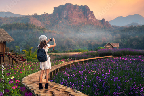 Fototapeta Flower in garden at Phu pha muak with asian woman traveller