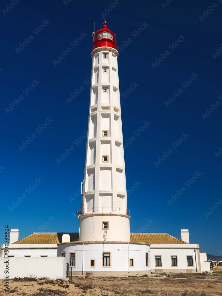 lighthouse Santa Maria of Farol Island at the Algarve coast of Portugal