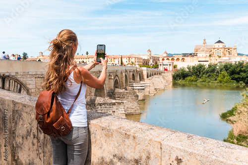 Woman taking photography with smartphone the view of Cordoba city - Spain, Andalusia photo