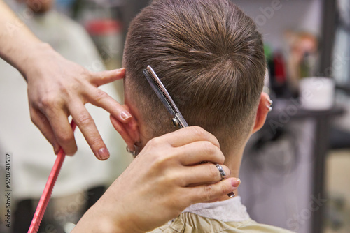 barber cutting hair with scissors. Haircut service. Man hairstyle © Alexandra Selivanova