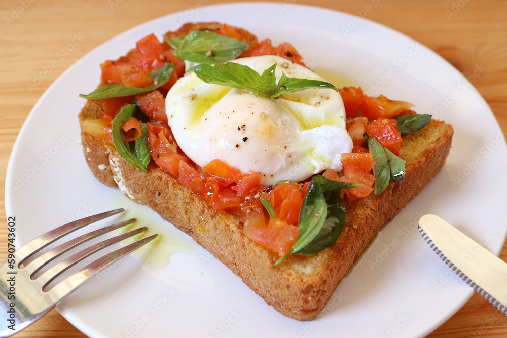 Plate of Mouthwatering Fresh Tomato and Basil Toast Topped with Poached Egg Plate of Mouthwatering Fresh Tomato and Basil Toast Topped with Poached Egg
