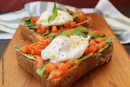 Tasty and Healthy Fresh Tomato and Basil Toast Topped with Poached Egg