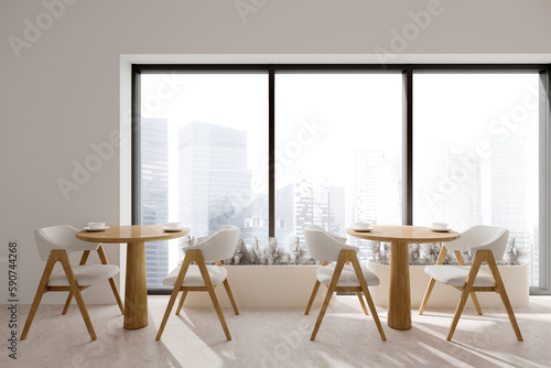 Photography White cafe interior with two wooden tables and seats, panoramic window