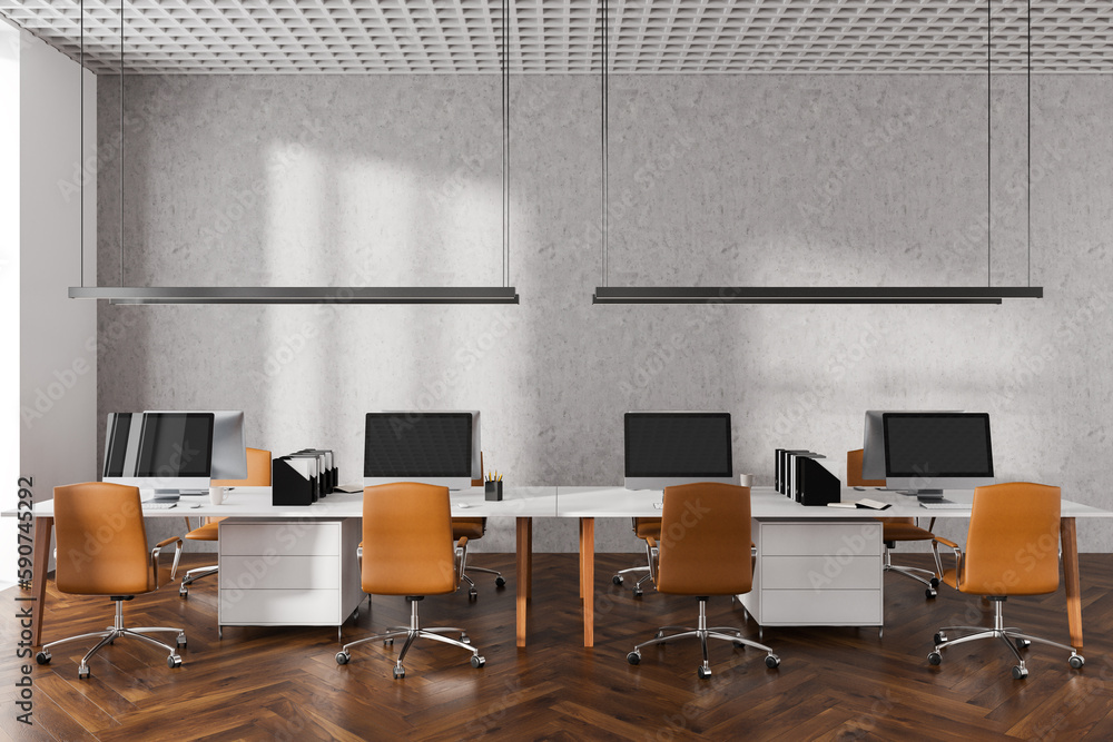 Cozy office interior with pc computer in row, armchairs on hardwood floor Cozy office interior with pc computer in row, armchairs on hardwood floor