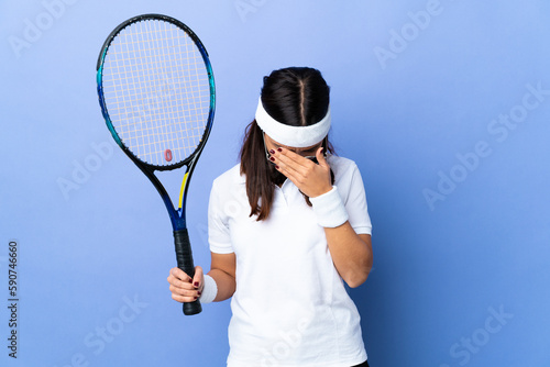 Young woman tennis player over isolated background with tired and sick expression © luismolinero